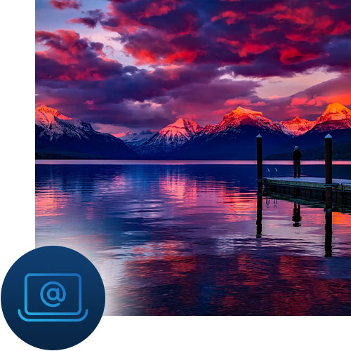 Mountains in the sunset over a lake with a pier. Computer icon representing Tour Marketing Suite offering SEO services to a variety of travel businesses.