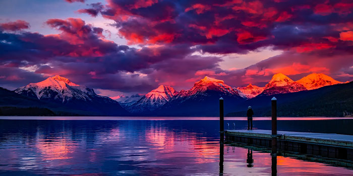 Mountains in the sunset over a lake with a pier. Representing Tour Marketing Suite's passion for promoting your brand.